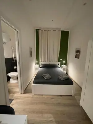 a bedroom with a bed and a bathroom with a toilet at Rome Groove Rooms in Rome