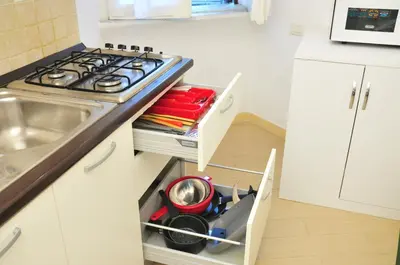 a kitchen with a stove and a sink at CARDINAL STUDIO - 2 steps from Vatican & Ottaviano metro in Rome