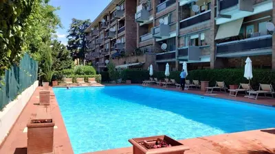 a swimming pool in front of a building at Sunshine Suite in Rome