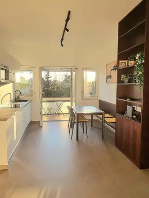 a kitchen with a table and a dining room at Sunshine Suite in Rome