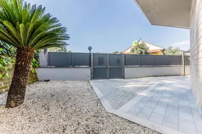 a palm tree in front of a fence at Al 32C del Gianicolo in Rome