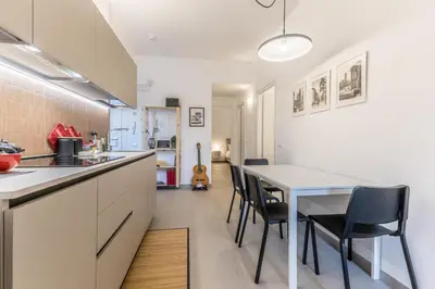 a kitchen and dining room with a table and chairs at Al 32C del Gianicolo in Rome