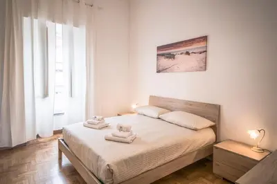a bedroom with a bed with towels on it at Esa apartment Flaminio in Rome