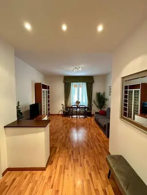 a living room with a wooden floor and a couch at Interno 3 - Vatican Apartment in Rome