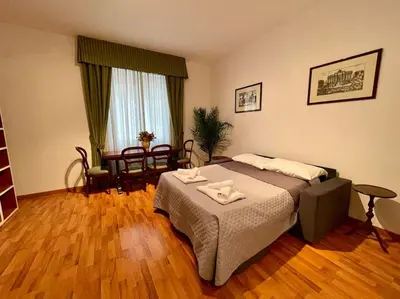 a bedroom with a bed and a table and chairs at Interno 3 - Vatican Apartment in Rome