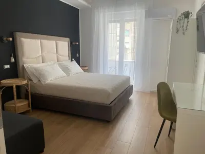 a bedroom with a large bed and a table at Wow Rome Home in Rome