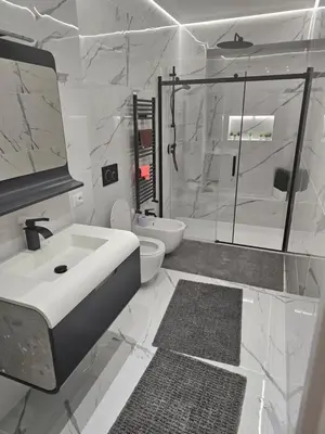 a white bathroom with a sink and a shower at EMHouse in Rome
