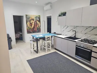 a kitchen with a table and a counter top at EMHouse in Rome