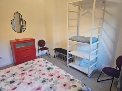 a bedroom with a bunk bed and a dresser at EMHouse in Rome