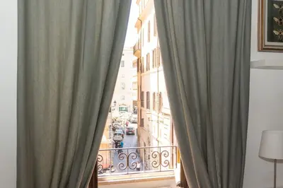 a view of a city from a balcony with curtains at Antuela Pantheon in Rome