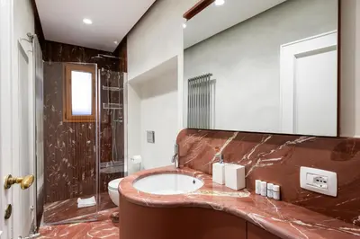 a bathroom with a sink and a shower at My Trevi Suite & Apartment in Rome