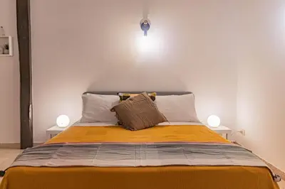 a bedroom with a bed with two lamps on it at Porta Pia - cozy flat in Rome