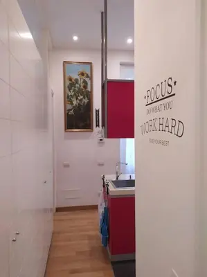 a kitchen with a sink and a painting on the wall at Irori Boutique House in Rome