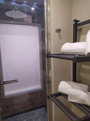 a bathroom with a window with towels on shelves at Irori Boutique House in Rome