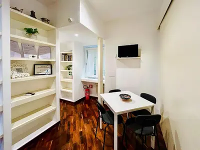 a small white table and chairs in a room at Suite Vaticana 9 in Rome