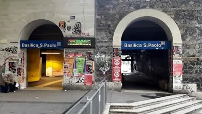 a building with two archways with graffiti on it at Simon's House in Rome