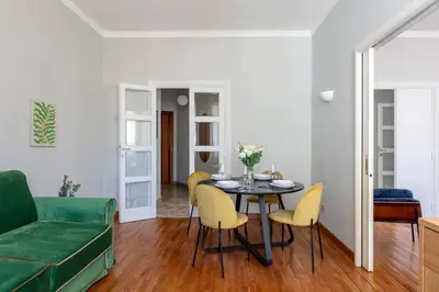 a living room with a table and yellow chairs at Casa Fontanella by Hili in Rome