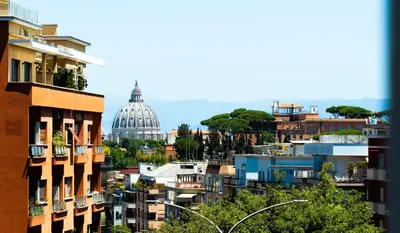 a view of a city with a dome in the background at Near Vatican, Irnerio 47 Guest House in Rome