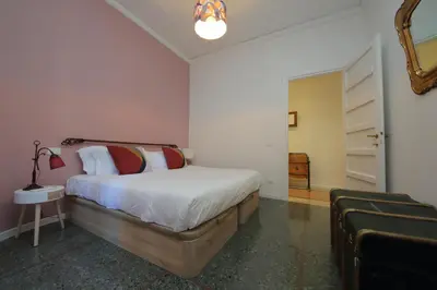 a bedroom with a bed and a couch at YCH-Vintage flat near San Giovanni in Rome