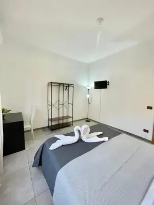 a bedroom with two towels on a bed at gt TRASTEVERE STATION HOUSE in Rome