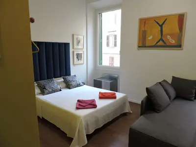 a bedroom with a bed and a couch at Art Lab Residence in Rome