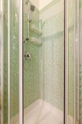 a bathroom with a shower with green tiles at Modern apartment in Portuense in Rome