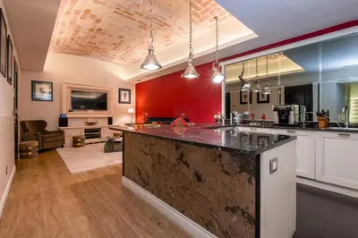a kitchen with a large counter top in a room at La Casa dei Sogni Roma in Rome