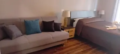 a living room with a couch and a bed at Rondinini Flam in Rome