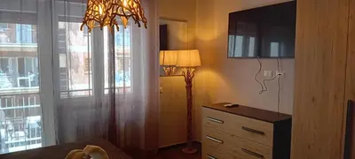 a bedroom with a lamp and a dresser with a television at Rondinini Flam in Rome