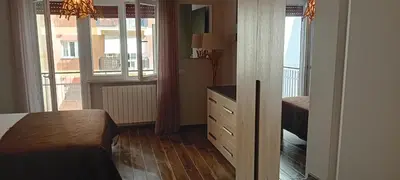 a bedroom with a dresser and a bedroom with windows at Rondinini Flam in Rome