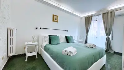 a bedroom with a green bed with towels on it at Sonia Monteverde Apartment per 4 in Rome