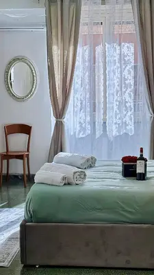 a bedroom with a bed with a window and a chair at Sonia Monteverde Apartment per 4 in Rome