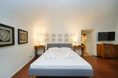 a bedroom with a white bed with two pillows at Pantheon's Arch by BuddyRent in Rome