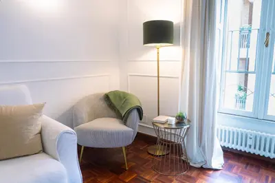 a living room with a couch and a chair and a window at Luxury Stay Piazza di Spagna in Rome