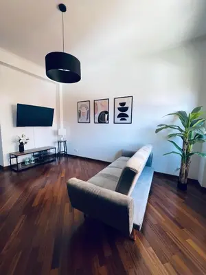 a living room with a couch and a flat screen tv at Casa Giulia Monteverde in Rome