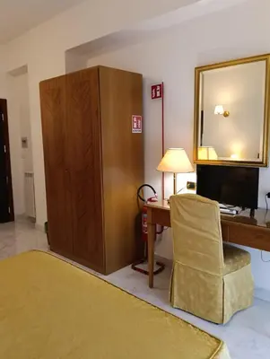 a hotel room with a bed and a desk at Monolocale Roma metro A Cornelia in Rome