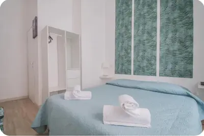 a bedroom with a bed with towels on it at Green House in Rome