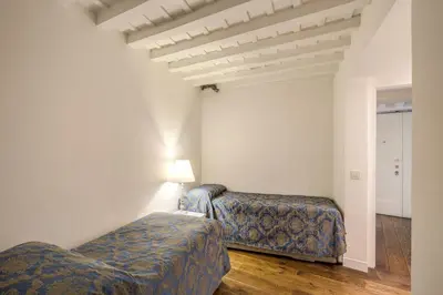 a room with two beds and a lamp in it at La Residenza del Sole al Pantheon in Rome