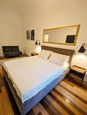 a bedroom with a large bed and a mirror at Luxury Gallery Suites in Rome