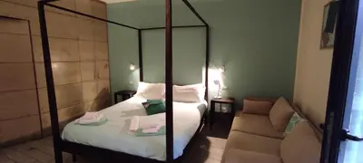 a bedroom with two beds and a mirror and a couch at HomeFlat in Rome
