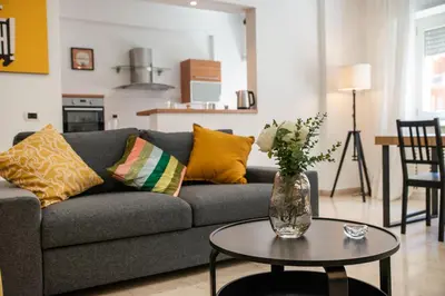a living room with a gray couch and a table at Bernadette Apartment - Vaticano area in Rome