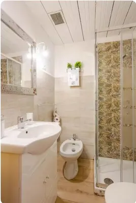 a bathroom with a sink and a toilet and a shower at Minisuite a Borgo Pio 
