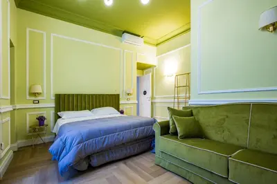 a door leading into a hallway with green walls at Hold Rome - Luxury Suites in Rome