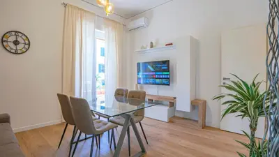 a dining room with a glass table and chairs at Casa Bonnet - Elegant Stay near Trastevere & Gianicolo in Rome