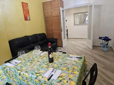 a table with a bottle of wine on top of it at Mary House in Rome