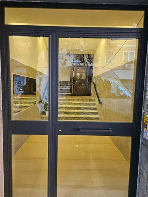 a view through a glass door of a store at Mary House in Rome