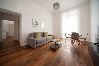 a living room with a couch and a table at Luxury apartment with Vatican views in Rome