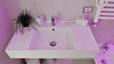 a white sink in a bathroom with a plant at Centro Solferino Rooms in Rome