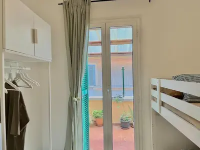 a room with a sliding glass door to a patio at Roma San Pietro rooftop view in Rome