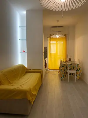 a room with a bed and a table with a yellow door at Dany & Manu House in Rome